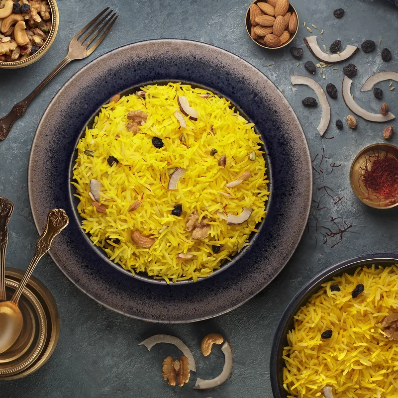 Cooked 1401 basmati rice served in a blue ceramic bowl