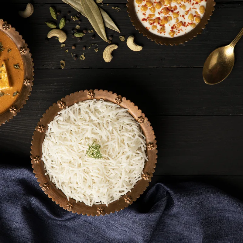 Cooked PR long grain non-basmati rice in a dark bowl
