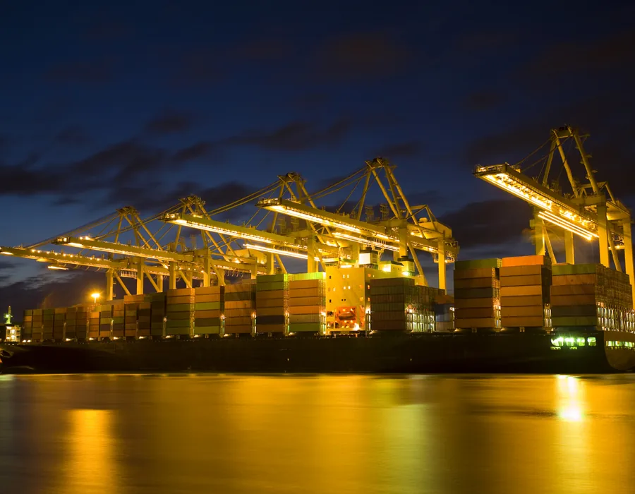 Container vessel loading at an Indian west-coast port at dusk